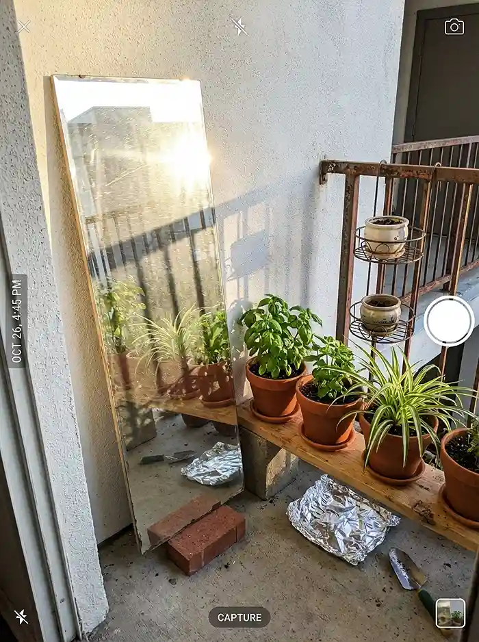 Why Your Balcony Garden Isn't Growing 4 DIY mirror and vertical shelf setup reflecting sunlight onto balcony plants