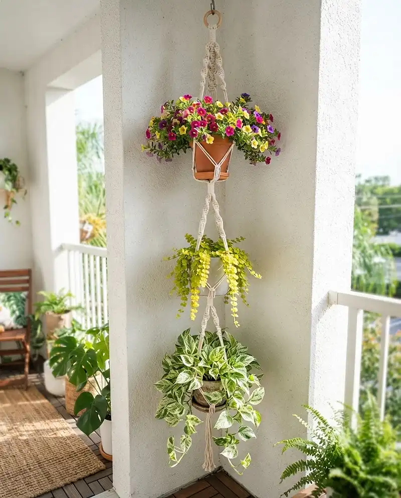 Balcony Corner Hanging Planters That Save Space 3 Hanging planter ideas for balcony corners shown as a three-tiered macrame hanger stacking pothos, creeping Jenny, and calibrachoa on one hook.