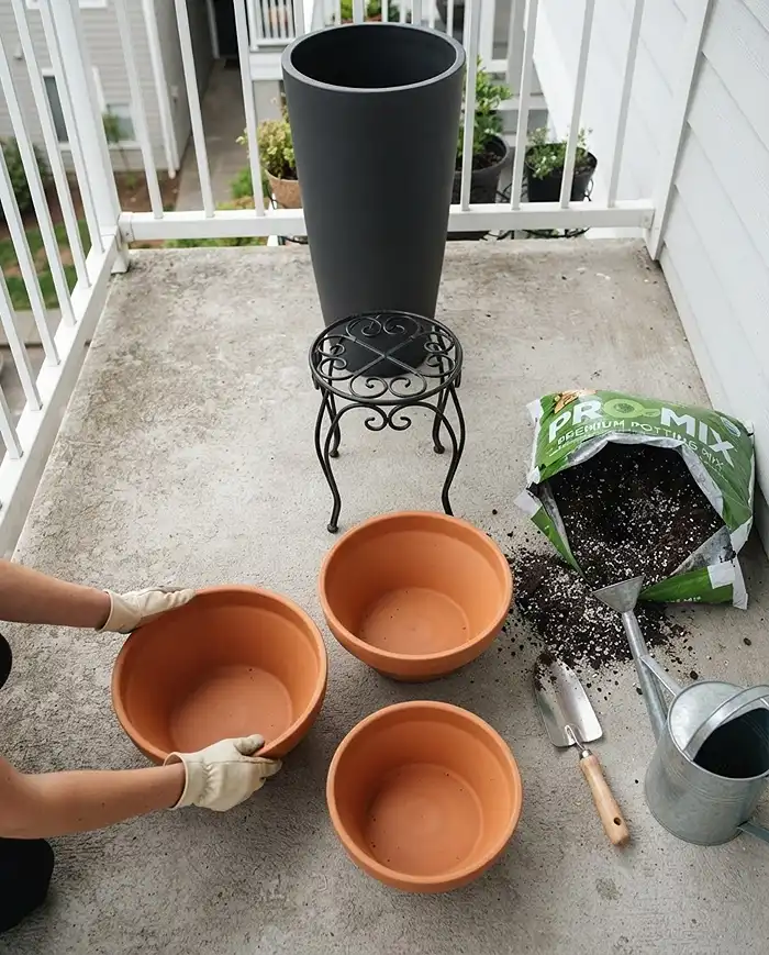 Layered Balcony Planters 4 Placing empty background pots and stands first to set spacing before filling and planting a layered display