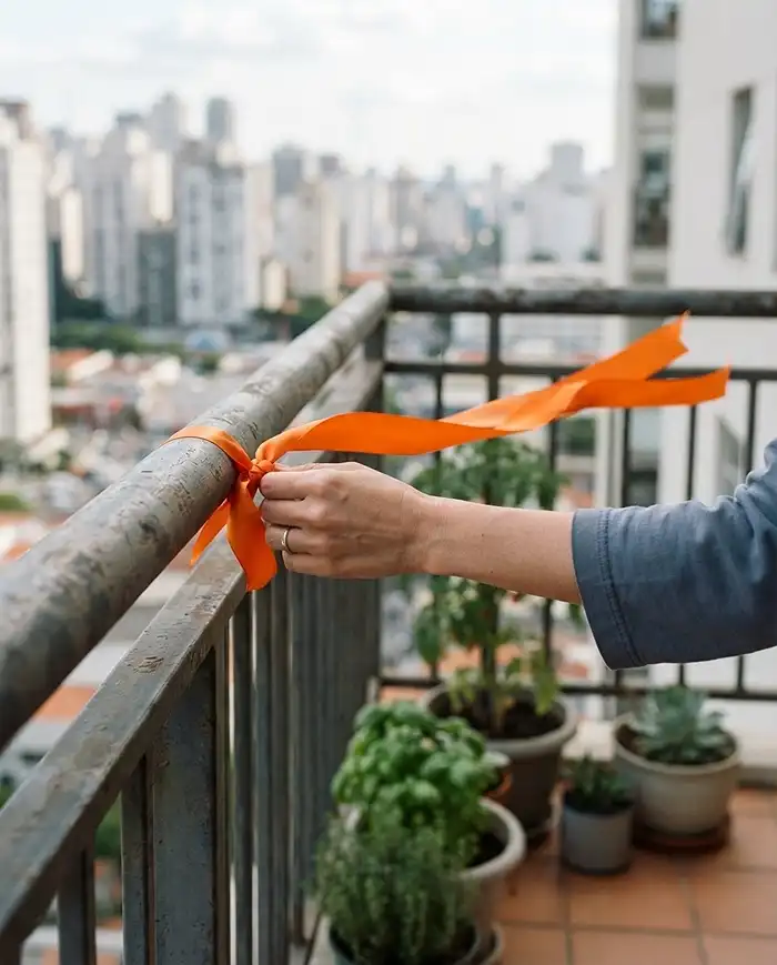 Renter Friendly Balcony Garden: Zero-Drill Looks 2 Ribbon tied to a balcony railing streaming in the wind to map gust direction before setup.
