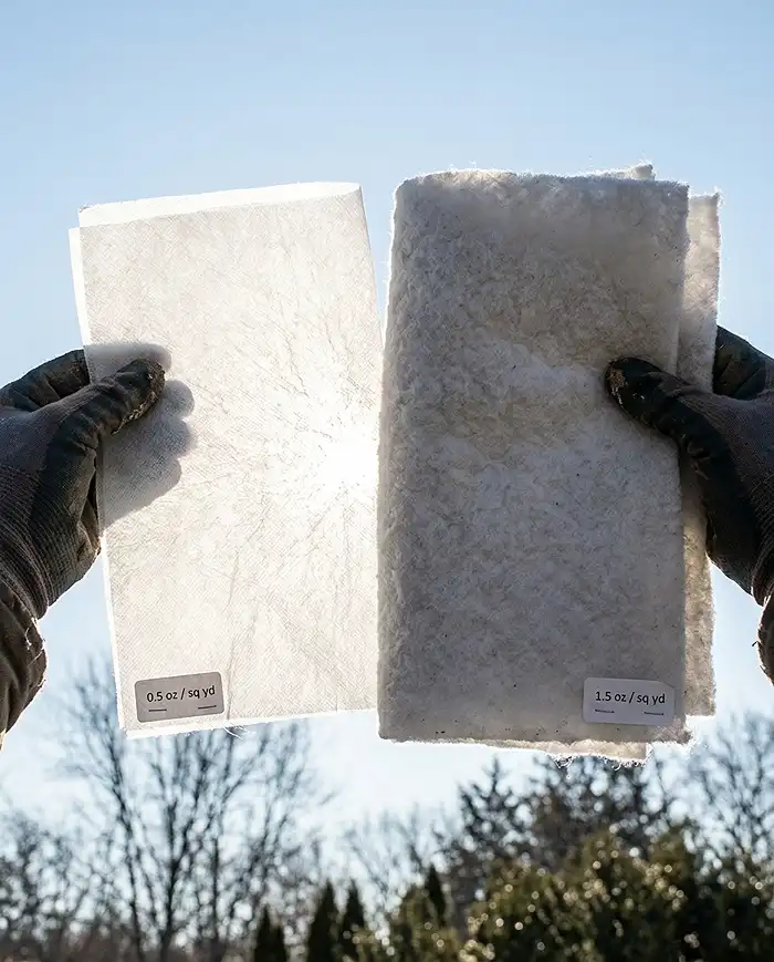 Light passing through thin frost cloth but blocked by thick fleece held side by side, showing the weight and breathability difference